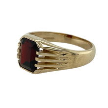 Load image into Gallery viewer, Rich in colour and classic in style, this pre-owned 9ct yellow gold garnet signet ring offers a bold, refined look—perfect for everyday elegance or a statement with meaning.

Design: The ring features a 9mm by 7mm rectangular garnet stone, bezel-set into a traditional signet style for a sleek and striking appearance.
Material: Made from 9-carat yellow gold, the polished finish complements the deep red hue of the garnet with warmth and contrast.

