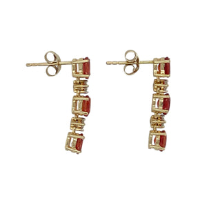 Vibrant and eye-catching, these pre-owned 9ct yellow gold drop earrings feature warm-toned stones and elegant sparkle—perfect for adding colour and movement to your look.

Design: Each earring showcases three 5mm by 4mm oval orange stones arranged vertically, separated by sparkling cubic zirconia stones for a balanced and radiant design.
Material: Made from 9-carat yellow gold, the polished finish enhances the rich colour of the orange stones and the brilliance of the cubic zirconia accents.
