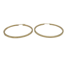 Load image into Gallery viewer, Bold and timeless, these pre-owned 9ct yellow gold large hoop creole earrings offer classic elegance with everyday versatility—perfect for effortless statement style.

Design: Each earring features a smooth, plain large hoop in a traditional creole shape, offering a clean and polished look.
Material: Made from 9-carat yellow gold, the high-shine finish enhances the warm tone and sleek silhouette.
Earring Detail: The larger size provides noticeable presence while maintaining a lightweight, comfortable feel.

