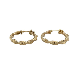 Elegant with a touch of texture, these pre-owned 9ct yellow gold twisted hoop creole earrings offer a stylish update to a classic design—perfect for everyday wear or adding subtle interest.

Design: Each earring features a traditional creole hoop with a gentle twist, creating movement and visual depth in a sleek, circular form.
Material: Made from 9-carat yellow gold, the polished finish enhances the twisted design with a warm, lustrous shine.
