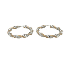 Load image into Gallery viewer, Elegant and eye-catching, these pre-owned 9ct yellow and white gold twisted hoop creole earrings feature a fluid two-tone design—perfect for versatile styling with a modern twist.

Design: Each earring showcases a classic hoop with an elegant twist, blending yellow and white gold in an intertwined design for subtle contrast and movement.
Material: Made from 9-carat yellow and white gold, the polished finish enhances the flowing curves and highlights the soft interplay of tones.

