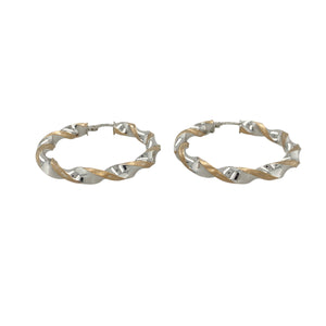 Elegant and eye-catching, these pre-owned 9ct yellow and white gold twisted hoop creole earrings feature a fluid two-tone design—perfect for versatile styling with a modern twist.

Design: Each earring showcases a classic hoop with an elegant twist, blending yellow and white gold in an intertwined design for subtle contrast and movement.
Material: Made from 9-carat yellow and white gold, the polished finish enhances the flowing curves and highlights the soft interplay of tones.

