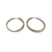 Load image into Gallery viewer, Elegant and eye-catching, these pre-owned 9ct yellow and white gold creole earrings feature a stylish double twist design—perfect for adding texture and two-tone charm to any look.

Design: Each earring showcases an oval creole shape with an intricate double twist, blending yellow and white gold with fine patterning for added depth and movement.
Material: Made from 9-carat yellow and white gold, the polished and textured finishes highlight the contrast between tones and enhance the flowing design.

