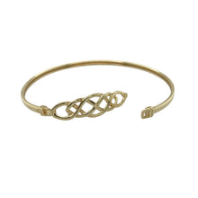 Load image into Gallery viewer, Elegant and symbolic, this pre-owned 9ct yellow gold Celtic knot bangle combines timeless design with meaningful detail—perfect for everyday sophistication or special occasions.

Design: The bangle features an intricate Celtic knot pattern at the front, measuring 9mm high, representing eternity and interconnectedness in a beautifully flowing design.
Material: Made from 9-carat yellow gold, the polished finish enhances the detailed knotwork with a warm, traditional glow.

