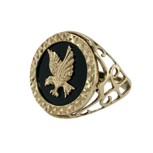 Load image into Gallery viewer, Bring bold symbolism and striking contrast to your jewellery collection with this pre-owned 9ct gold eagle signet ring, featuring a deep onyx background and open patterned shoulders—perfect for a confident, statement look.

Design: The ring features a 22mm high face with a detailed gold eagle set against a polished black onyx backdrop, creating a powerful and eye-catching centrepiece.

