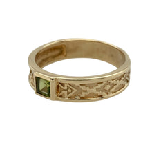 Load image into Gallery viewer, Bring vibrant colour and unique style to your collection with this pre-owned 9ct yellow gold peridot patterned band ring—perfect for adding a touch of individuality and warmth to any look.

Design: The ring features a 5mm wide band with an intricate patterned design, accented by a single peridot for a fresh pop of green.
Material: Made from 9-carat yellow gold, the polished finish enhances the warmth of the gold and the vivid tone of the gemstone.

