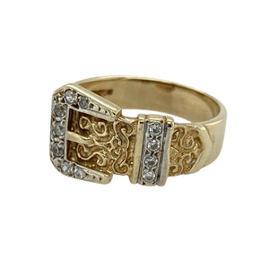 Bring vintage charm and sparkling detail to your collection with this pre-owned 9ct yellow gold cubic zirconia patterned buckle ring—perfect for adding a unique and symbolic touch to your style.

Design: The ring features a 12mm high buckle design at the front, adorned with cubic zirconia stones that add light and brilliance to the patterned detailing.
Material: Made from 9-carat yellow gold, the polished finish enhances the warm tone of the metal and highlights the intricate buckle motif.
