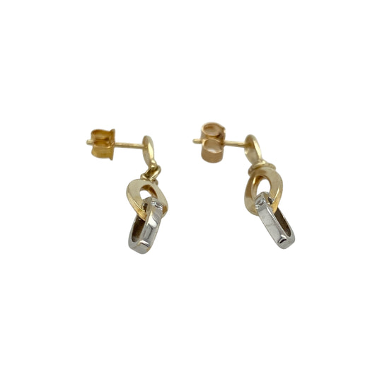 Bring contemporary elegance and a touch of sparkle to your collection with these pre-owned 9ct yellow and white gold two interlocking oval loop drop earrings—perfect for adding modern style to any look.

Design: Each earring features two interlocking oval loops, one in yellow gold and one in white gold, accented by a small cubic zirconia for subtle brilliance.
Material: Made from 9-carat yellow and white gold, the polished finish enhances the contrast between the metals and the sparkle of the stones.
