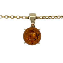 Load image into Gallery viewer, Bring warm tones and natural beauty to your collection with this pre-owned 9ct yellow gold and amber round pendant on an 18&quot; belcher chain—perfect for adding earthy elegance to any look.

Design: The necklace features a 2.4cm long round pendant, including the bail, set with a 13mm diameter amber stone that displays its rich golden-brown hues.
Material: Made from 9-carat yellow gold, the polished finish complements the amber’s warm glow and highlights the smooth belcher chain.

