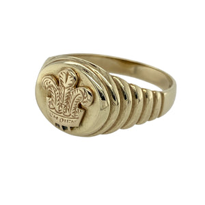 Bring heritage style and bold presence to your collection with this pre-owned 9ct yellow gold three feathers oval signet ring—perfect for those who appreciate meaningful symbolism and timeless design.

Design: The ring features a 13mm high oval face engraved with the iconic three feathers emblem, adding historic and cultural significance.
Material: Made from 9-carat yellow gold, the polished finish enhances the warm tone and highlights the detailed engraving.
