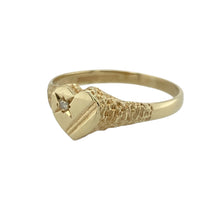 Load image into Gallery viewer, Bring sweet charm and subtle sparkle to your collection with this pre-owned 9ct yellow gold diamond heart signet ring—perfect for adding a touch of romance to any look.

Design: The ring features a 7mm high heart-shaped front with a patterned finish, accented by a single diamond for a hint of brilliance.
Material: Made from 9-carat yellow gold, the polished surface enhances the warm tone and highlights the intricate detailing.

