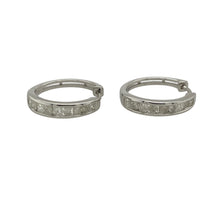 Load image into Gallery viewer, Bring modern elegance and subtle sparkle to your collection with these pre-owned 9ct white gold diamond hoop earrings—perfect for adding a touch of sophistication to both day and evening looks.

Design: Each hoop is accented with diamonds along the front, offering a refined shimmer that catches the light beautifully.
Material: Made from 9-carat white gold, the cool-toned finish enhances the brilliance of the diamonds and delivers a sleek, contemporary feel.

