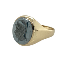 Load image into Gallery viewer, Bring bold character and distinctive style to your collection with this pre-owned 9ct yellow gold hematite centurion signet ring—perfect for those who appreciate strong design with a touch of history.

Design: The ring features an oval hematite stone measuring approximately 14mm by 12mm, engraved with a centurion motif for a striking and detailed finish.
Material: Made from 9-carat yellow gold, the polished setting provides a warm contrast to the dark metallic sheen of the hematite.

