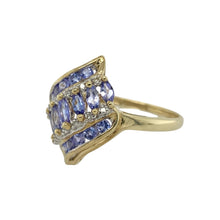 Load image into Gallery viewer, Bring vibrant colour and sparkling elegance to your collection with this pre-owned 9ct yellow gold diamond and tanzanite fancy ring—perfect for making a statement with refined style.

Design: The 2cm wide front is arranged in three rows of tanzanite stones alternating with two rows of diamonds, creating a bold and eye-catching pattern.
Material: Made from 9-carat yellow gold, the polished finish enhances the rich violet-blue tones of the tanzanite and the brilliance of the diamonds.

