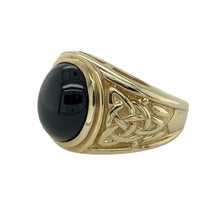 Load image into Gallery viewer, Bring bold style and symbolic detail to your collection with this pre-owned 9ct yellow gold and onyx Celtic knot patterned signet ring—an eye-catching piece with timeless appeal.

Design: The ring showcases a 12mm by 10mm oval onyx stone at the centre, framed by detailed Celtic knot shoulders that add heritage-inspired character.
Material: Made from 9-carat yellow gold, the polished finish enhances the deep contrast of the black onyx and highlights the intricate knotwork.

