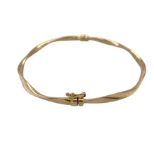 Load image into Gallery viewer, Bring subtle elegance and golden style to your collection with this pre-owned 9ct yellow gold twist hinged bangle—a refined piece suited to both everyday wear and special occasions.

Design: The bangle features a delicate twist pattern with a hinged opening, combining decorative detail with practical wearability.
Material: Made from 9-carat yellow gold, the polished finish enhances the flowing design and timeless appeal.

