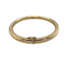 Load image into Gallery viewer, Bring bold style and golden elegance to your collection with this pre-owned 9ct yellow gold striped patterned hinged bangle—a substantial piece with timeless appeal.

Design: The bangle features a striped pattern across the surface with a hinged opening, combining decorative detail with practical wearability.
Material: Made from 9-carat yellow gold, the polished finish highlights the striped design and enhances its classic character.

