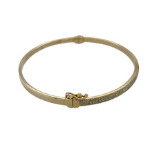 Load image into Gallery viewer, Bring shimmer and elegance to your collection with this pre-owned 9ct yellow gold sparkle hinged bangle—a refined piece perfect for everyday wear or special occasions.

Design: The bangle features a sparkle finish along the surface with a hinged opening, combining eye-catching detail with practical wearability.
Material: Made from 9-carat yellow gold, the polished surface enhances the sparkle texture and adds timeless appeal.

