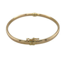 Load image into Gallery viewer, Bring classic elegance and everyday versatility to your collection with this pre-owned 9ct yellow gold plain hinged bangle—a timeless piece suited to any occasion.

Design: The bangle features a smooth plain finish with a hinged opening, offering both simplicity and practicality.
Material: Made from 9-carat yellow gold, the polished surface enhances its warm tone and classic style.
Bangle Detail: Measuring 4mm in width with a diameter of 6.5cm, the design balances understated elegance with comfortable wear.
