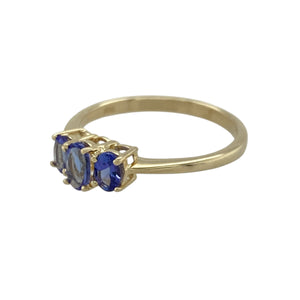 Bring refined colour and delicate elegance to your collection with this pre-owned 9ct yellow gold tanzanite trilogy ring, offering subtle sparkle and timeless sophistication—perfect for everyday wear or special occasions.

Design: Showcasing a trilogy of oval tanzanite stones, the centre measuring 5mm by 3mm and flanked by two 4mm by 2mm stones, the ring creates a balanced and graceful look with soft violet-blue hues.
