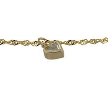 Load image into Gallery viewer, Bring delicate sparkle and playful elegance to your collection with this pre-owned 9ct yellow gold anklet, featuring a heart-shaped cubic zirconia drop for a charming finish—perfect for adding a touch of shine to summer or everyday style.

Design: The 10&quot; anklet is crafted with fine 2mm links and finished with a 4mm by 5mm heart-shaped cubic zirconia drop, creating a dainty yet eye-catching look.

