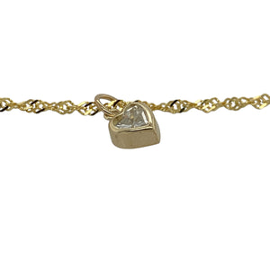 Bring delicate sparkle and playful elegance to your collection with this pre-owned 9ct yellow gold anklet, featuring a heart-shaped cubic zirconia drop for a charming finish—perfect for adding a touch of shine to summer or everyday style.

Design: The 10" anklet is crafted with fine 2mm links and finished with a 4mm by 5mm heart-shaped cubic zirconia drop, creating a dainty yet eye-catching look.
