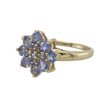 Load image into Gallery viewer, Bring vibrant colour and sparkling elegance to your collection with this pre-owned 14ct yellow gold diamond and tanzanite flower cluster ring—a striking design with timeless charm.

Design: The ring features a floral cluster design with vivid tanzanite stones surrounded by diamonds, forming a bold 13mm high front that captures the light beautifully.
Material: Made from 14-carat yellow gold, the polished finish enhances the rich colour of the tanzanite and the brilliance of the diamonds.

