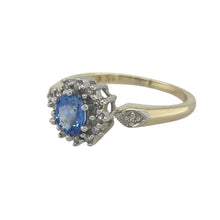 Load image into Gallery viewer, Bring classic elegance and timeless sparkle to your collection with this pre-owned 9ct yellow gold diamond and sapphire cluster ring—a refined piece with enduring charm.

Design: The ring showcases a 5mm by 4mm oval sapphire at the centre, surrounded by a cluster of diamonds that enhance its deep blue hue with brilliant contrast.
Material: Made from 9-carat yellow gold, the polished finish highlights the sapphire’s rich colour and the sparkle of the diamonds.

