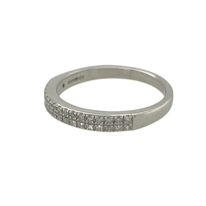 Bring refined sparkle and modern elegance to your collection with this pre-owned 9ct white gold two row diamond band ring—a timeless design with subtle brilliance.

Design: The ring features a 2.5mm wide band with two rows of diamonds along the front, totalling approximately 0.10ct of diamond content for delicate sparkle.
Material: Made from 9-carat white gold, the polished finish enhances the contemporary style and complements the shimmer of the diamonds.
