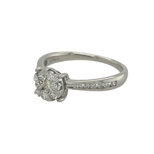 Bring timeless sparkle and refined style to your collection with this pre-owned 9ct white gold diamond illusion solitaire ring—a classic design with impressive brilliance.

Design: The ring features a central illusion-set cluster designed to create the look of a larger solitaire stone, with approximately 0.50ct of diamond content in total.
Material: Made from 9-carat white gold, the polished finish enhances the brilliance of the diamonds and adds modern appeal.
 