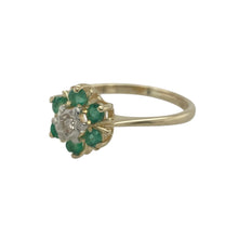 Load image into Gallery viewer, Bring vibrant colour and sparkling elegance to your collection with this pre-owned 9ct yellow gold diamond and emerald cluster ring—a timeless design with classic charm.

Design: The ring features a 9mm wide cluster front, showcasing a central diamond surrounded by rich green emeralds for a striking contrast.
Material: Made from 9-carat yellow gold, the polished finish enhances the brilliance of the diamond and the vivid tones of the emeralds.

