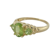 Load image into Gallery viewer, Bring vintage charm and colourful elegance to your collection with this pre-owned 9ct yellow gold opalique and garnet cluster ring—a classic design with timeless appeal.

Design: The ring features a 6mm by 4mm oval opalique stone at the centre, surrounded by deep red garnets in a traditional cluster arrangement.
Material: Made from 9-carat yellow gold, the polished finish enhances the fiery play of colour in the opalique and the rich tones of the garnets.

