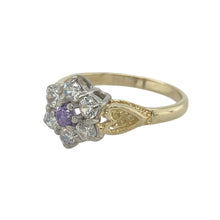 Load image into Gallery viewer, Bring vibrant colour and sparkling detail to your collection with this pre-owned 9ct yellow gold purple stone and cubic zirconia flower cluster ring—a bold design with timeless elegance.

Design: The ring features an 11mm high floral cluster, with a central purple stone surrounded by cubic zirconia for brilliance and contrast.
Material: Made from 9-carat yellow gold, the polished finish enhances the vivid tone of the purple stone and the sparkle of the cubic zirconia.

