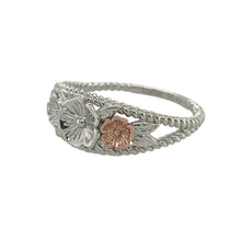 Load image into Gallery viewer, Bring floral elegance and timeless charm to your collection with this pre-owned Clogau silver and 9ct rose gold flower blossom band ring—a meaningful design inspired by nature.

Design: The band features a 9mm wide front decorated with delicate flower blossom motifs, highlighted with touches of rose gold for added warmth.
Material: Made from sterling silver with 9-carat rose gold detailing, the polished finish enhances the contrast between the metals and the intricate design.

