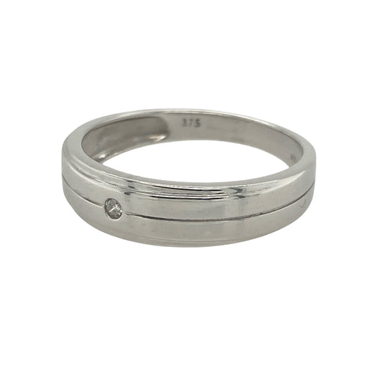 Bring refined sparkle and modern elegance to your collection with this pre-owned 9ct white gold diamond band ring—a timeless design with graceful presence.

Design: The ring features a 6mm wide band accented with diamonds across the front, offering brilliance and sophisticated style.
Material: Made from 9-carat white gold, the polished finish enhances the clean, contemporary look and the sparkle of the stones.
