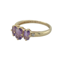 Load image into Gallery viewer, Bring vibrant colour and refined sparkle to your collection with this pre-owned 9ct yellow gold diamond and amethyst trilogy ring—a meaningful design with timeless elegance.

Design: The ring features a 6mm by 4mm rectangular amethyst at the centre, flanked by two 5mm by 3mm amethysts, accented with diamonds for added brilliance.
Material: Made from 9-carat yellow gold, the polished finish enhances the rich purple tones of the amethysts and the sparkle of the diamonds.

