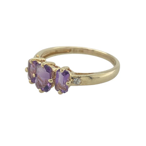 Bring vibrant colour and refined sparkle to your collection with this pre-owned 9ct yellow gold diamond and amethyst trilogy ring—a meaningful design with timeless elegance.

Design: The ring features a 6mm by 4mm rectangular amethyst at the centre, flanked by two 5mm by 3mm amethysts, accented with diamonds for added brilliance.
Material: Made from 9-carat yellow gold, the polished finish enhances the rich purple tones of the amethysts and the sparkle of the diamonds.

