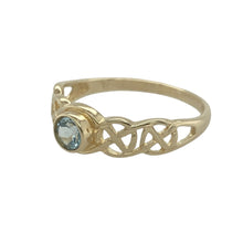 Load image into Gallery viewer, Bring vibrant colour and symbolic design to your collection with this pre-owned 9ct yellow gold blue topaz Celtic weave ring, blending rich tradition with a touch of modern elegance—perfect for meaningful everyday wear or special occasions.

Design: The ring showcases a 4mm round blue topaz at the centre, its bright hue beautifully contrasted by the intricate Celtic weave detailing.

