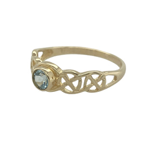 Bring vibrant colour and symbolic design to your collection with this pre-owned 9ct yellow gold blue topaz Celtic weave ring, blending rich tradition with a touch of modern elegance—perfect for meaningful everyday wear or special occasions.

Design: The ring showcases a 4mm round blue topaz at the centre, its bright hue beautifully contrasted by the intricate Celtic weave detailing.
