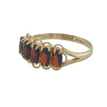 Load image into Gallery viewer, Bring deep colour and classic elegance to your collection with this pre-owned 9ct yellow gold garnet five stone ring, offering timeless style and rich warmth—perfect for both everyday wear and special occasions.

Design: The ring showcases five oval-cut garnets, each measuring 5mm by 3mm, arranged in a traditional row for a balanced and refined look.
Material: Made from 9-carat yellow gold, the polished finish enhances the garnets’ rich red tones and adds a touch of enduring sophistication.

