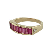 Load image into Gallery viewer, Bring rich colour and refined sparkle to your collection with this pre-owned 9ct yellow gold diamond and ruby band ring, offering timeless elegance with a bold profile—perfect for both everyday wear and special occasions.

Design: The front of the band measures 6mm wide and is set with baguette-cut rubies, accented by a small diamond on each shoulder for subtle brilliance.
Material: Made from 9-carat yellow gold, the polished finish enhances the deep red of the rubies and the sparkle of the diamonds.
