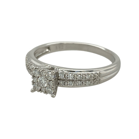 Bring brilliance and sophistication to your collection with this pre-owned 9ct white gold diamond cluster solitaire ring, combining timeless sparkle with a bold princess-style design—perfect for both everyday elegance and special occasions.

Design: The ring features a princess-style cluster arrangement with multiple diamonds, creating the appearance of a larger central stone for maximum impact.
