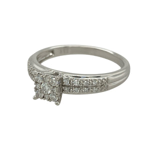 Bring brilliance and sophistication to your collection with this pre-owned 9ct white gold diamond cluster solitaire ring, combining timeless sparkle with a bold princess-style design—perfect for both everyday elegance and special occasions.

Design: The ring features a princess-style cluster arrangement with multiple diamonds, creating the appearance of a larger central stone for maximum impact.
