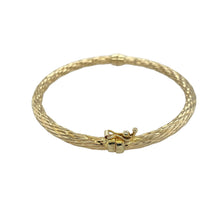 Load image into Gallery viewer, Add classic texture and style to your collection with this pre-owned 9ct yellow gold twisted patterned hinged bangle, offering timeless elegance and everyday versatility.

Design: The bangle features a twisted pattern design with a hinged opening, combining intricate detail with ease of wear.
Material: Made from 9-carat yellow gold, the polished finish highlights the textured design and adds a warm, luxurious glow.

