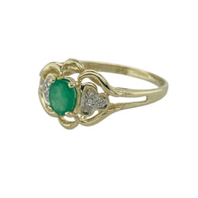 Load image into Gallery viewer, Bring vintage-inspired charm to your collection with this pre-owned 9ct yellow gold emerald and diamond ring, featuring a delicate filigree design and timeless elegance—perfect for everyday wear or special occasions.

Design: The ring showcases a 5mm by 4mm oval-cut emerald at the centre, highlighted by sparkling diamonds in an intricate filigree setting for added detail and character.
Material: Made from 9-carat yellow gold, the polished finish provides warmth and enhances the vibrant green of the emerald.
