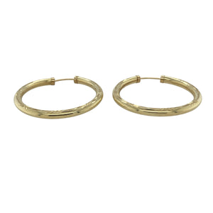 Bring texture and classic shine to your collection with these pre-owned 9ct yellow gold patterned hollow hoop earrings—a timeless style with elegant detailing.

Design: Each earring features a traditional hoop shape with a subtle patterned finish, adding depth and interest to the polished gold surface.
Material: Made from 9-carat yellow gold, the polished finish enhances the warm tone and highlights the decorative patterning.