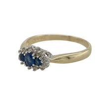 Load image into Gallery viewer, Bring classic elegance and timeless sparkle to your collection with this pre-owned 9ct yellow gold diamond and sapphire trilogy cluster ring—a refined design with symbolic meaning.

Design: The ring features a central oval sapphire measuring 4mm by 3mm, flanked by two smaller sapphires, all surrounded by a cluster of sparkling diamonds for a balanced and eye-catching look.

