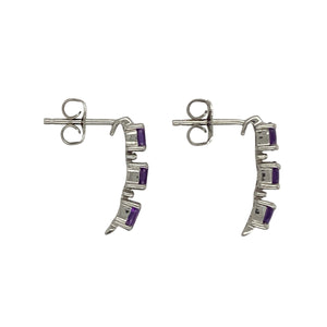 Bring vibrant colour and refined sparkle to your collection with these pre-owned 9ct white gold amethyst and diamond drop stud earrings—a graceful design with timeless charm.

Design: Each earring features three oval amethyst stones measuring 4mm by 3mm, arranged vertically with a small diamond set between each stone for added brilliance.
Material: Made from 9-carat white gold, the polished finish enhances the bright tone and beautifully complements the rich purple of the amethysts.