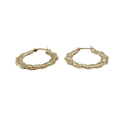 Bring texture and timeless style to your collection with these pre-owned 9ct yellow gold hoop earrings, designed in a twisted flat creole shape for added elegance.

Design: Each earring features a flat hoop with a subtle twist, creating a refined look that catches the light beautifully.
Material: Made from 9-carat yellow gold, the polished finish enhances the warm golden tone and shine.
Earring Detail: The creole style ensures secure wear while the twisted design adds a touch of modern sophistication.