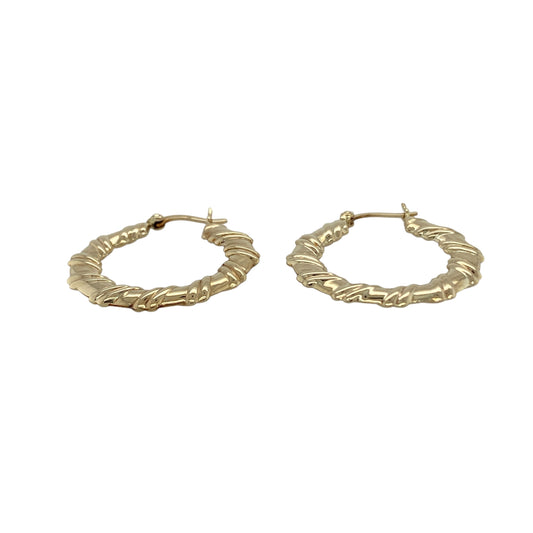 Bring texture and timeless style to your collection with these pre-owned 9ct yellow gold hoop earrings, designed in a twisted flat creole shape for added elegance.

Design: Each earring features a flat hoop with a subtle twist, creating a refined look that catches the light beautifully.
Material: Made from 9-carat yellow gold, the polished finish enhances the warm golden tone and shine.
Earring Detail: The creole style ensures secure wear while the twisted design adds a touch of modern sophistication.